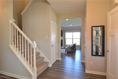 Foyer entrance with a textured ceiling and dark hardwood / wood-style flooring | Image 2