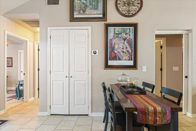 Dining area with visible vents, baseboards, and light tile patterned floors | Image 13