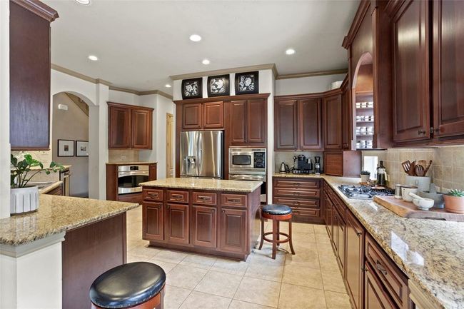 Large kitchen with plenty of cabinets, countertop space and Island. | Image 10