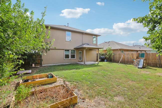 Spacious back yard with a play set and raised bed gardens! | Image 34