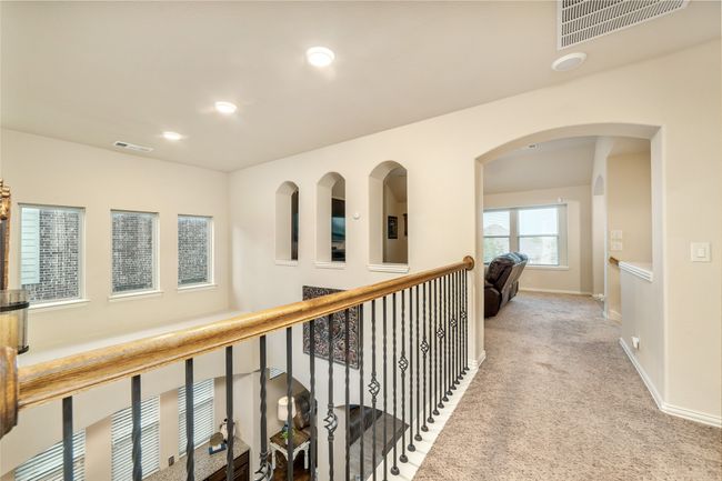 Corridor with carpet, baseboards, recessed lighting, and arched walkways | Image 30