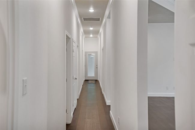 Corridor with dark wood finished floors and baseboards | Image 25