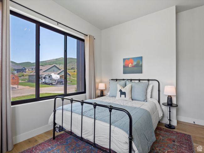 Bedroom featuring baseboards, wood finished floors, and a mountain view | Image 31
