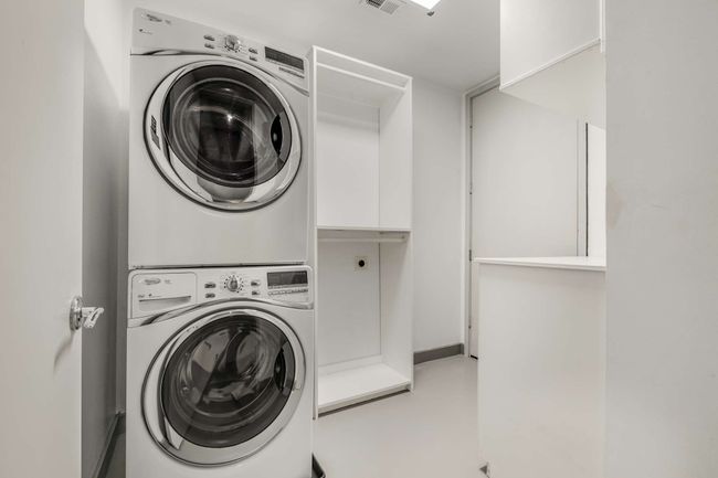 Laundry room with built in cabinetry and a storage closet. | Image 14