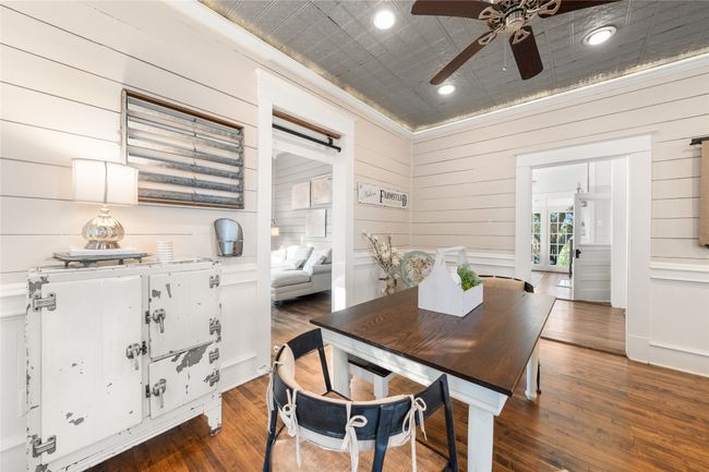 Dining space with ceiling fan, wood finished floors, wooden walls, and recessed lighting | Image 10