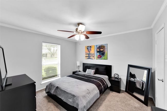 Carpeted bedroom with crown molding and a ceiling fan | Image 20