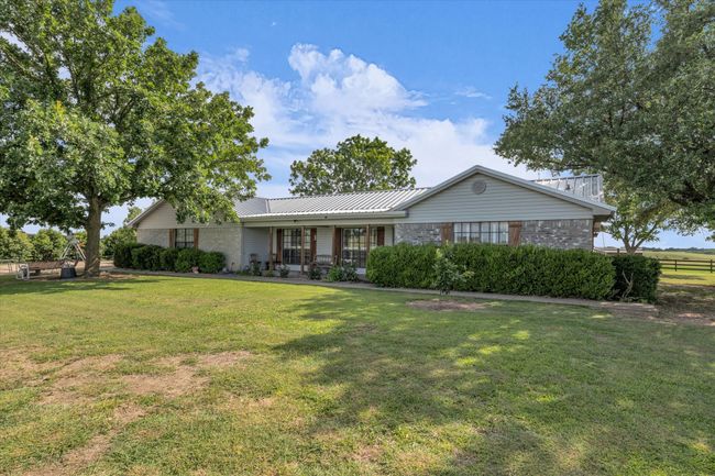 Ranch-style home with a front lawn and a metal roof | Image 20