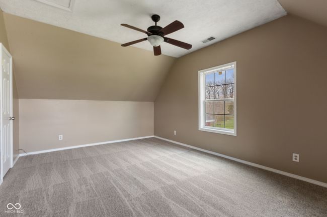 bonus room featuring visible vents, baseboards, a ceiling fan, vaulted ceiling, and carpet flooring | Image 27