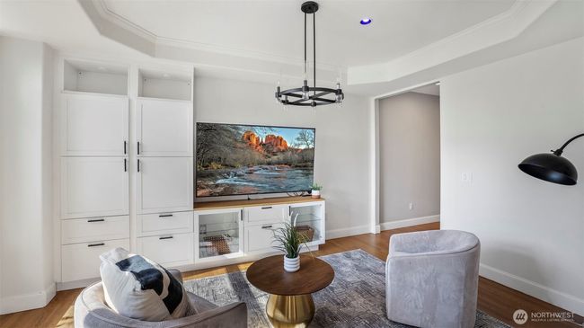 The built-in shelving and large white cabinets create a stylish focal point while giving the space a warm and welcoming feel! | Image 7