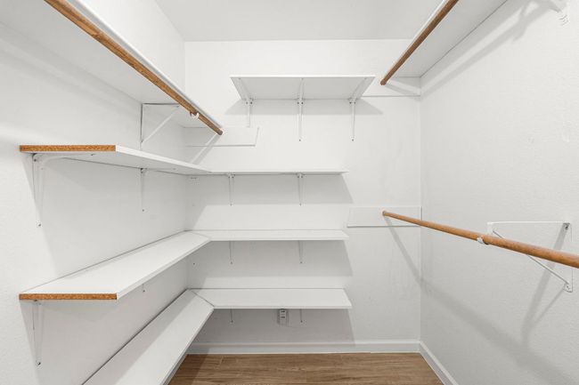 Spacious closet featuring wood finished floors | Image 21