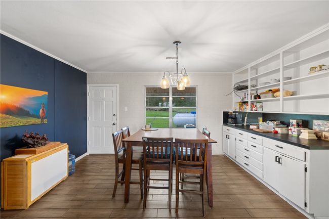 Dining room with a chandelier, dark hardwood / wood-style floors, and ornamental molding | Image 7