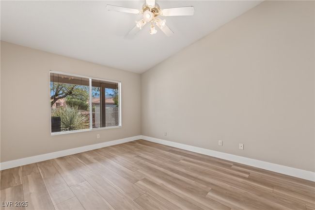 Unfurnished room with vaulted ceiling, light wood-type flooring, and a ceiling fan | Image 21