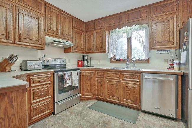 Solid oak raised panel oak cabinets with stainless appliances. | Image 15