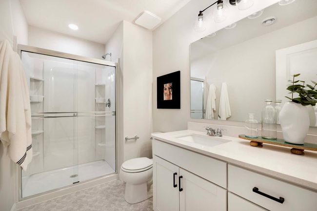 Lower level bath includes large shower and quartz countertops. | Image 25