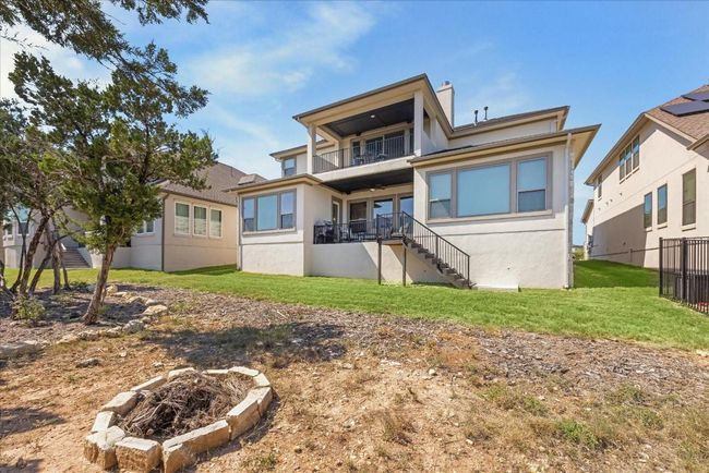 Here's a look at the back exterior of the home, showcasing both the lower and upper covered outdoor spaces. Inside AND outiside...there is so much to love in this home. Schedule your appt today to come see! | Image 39