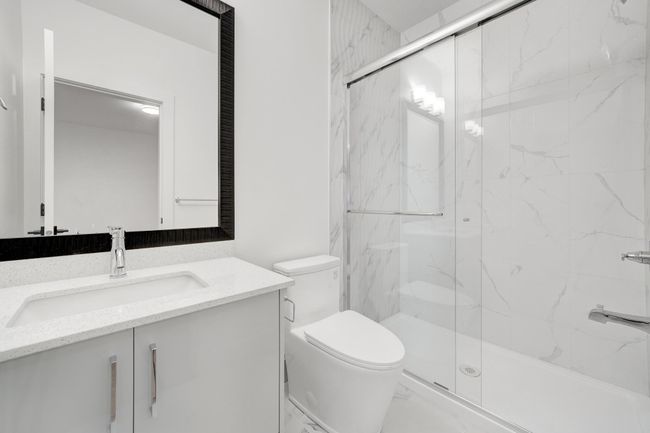 Bathroom with toilet, vanity, a marble finish shower, and marble finish floors | Image 27