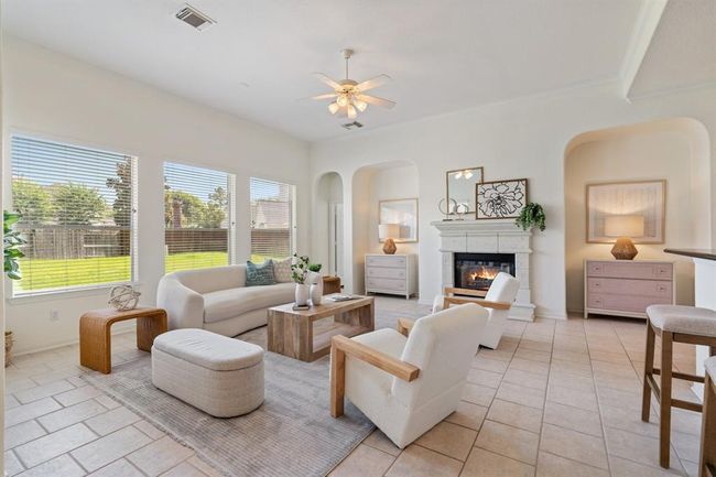 The open-concept floor plan is flooded with natural light, thanks to abundant windows throughout the living areas. | Image 6