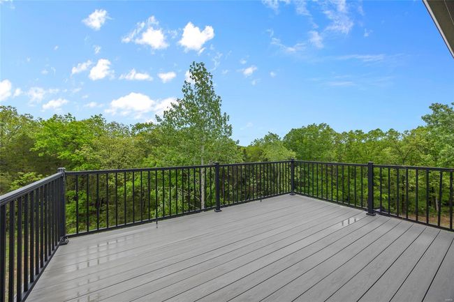 Wooden deck featuring a view of trees | Image 46