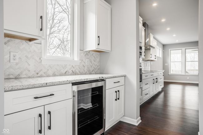 Butler's Pantry complete with tile backsplash and a wine fridge. | Image 20