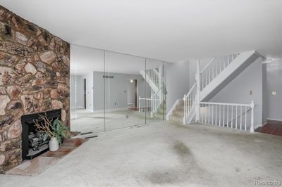 Living room with decorative stone fireplace | Image 3