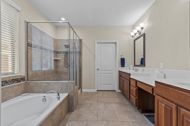 An inviting upstairs retreat, generously sized with plush carpet, a large picture window, and space to unwind in style. | Image 23