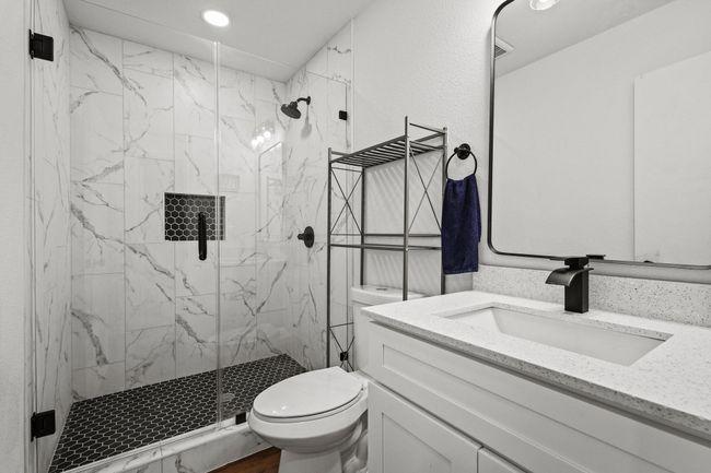 Full bath featuring toilet, a marble finish shower, vanity, and recessed lighting | Image 26