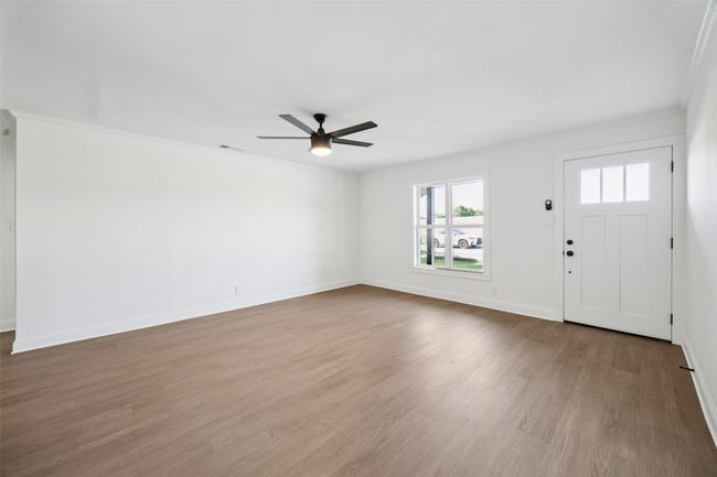 Entrance foyer with ceiling fan, wood finished floors, and crown molding | Image 12