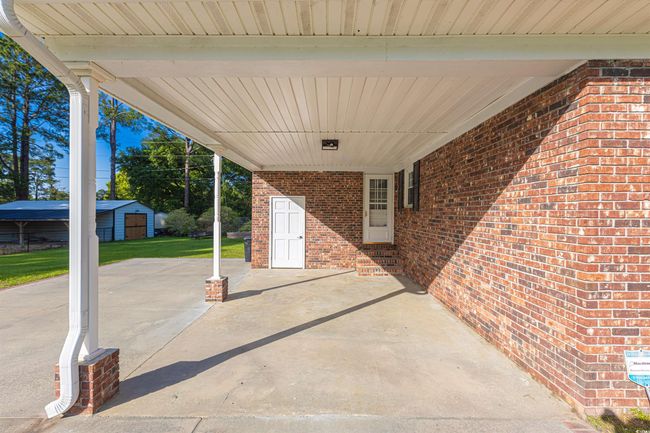 View of patio / terrace featuring a carport and entry steps | Image 23