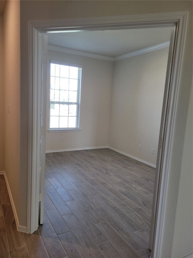 Unfurnished room featuring dark wood finished floors, baseboards, and crown molding | Image 8
