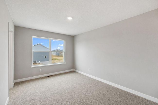 Primary bedroom with walk-in closet and private bath. Model home. Options and colors will vary. | Image 19