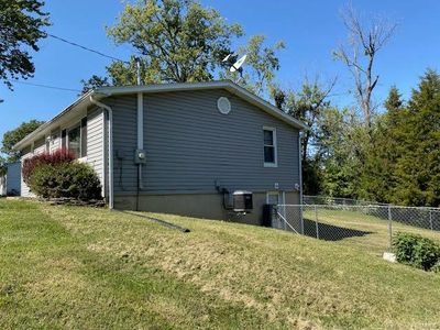 View of side of home with a yard and central air condition unit | Image 3