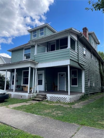 View of front of property with a porch and a front lawn | Image 1