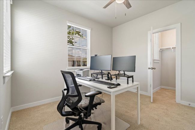 Office space featuring a ceiling fan and light colored carpet | Image 21