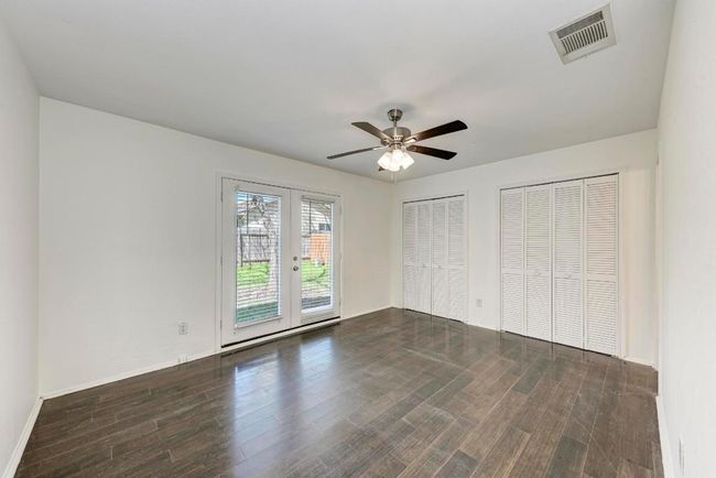 Unfurnished bedroom with access to exterior, visible vents, french doors, and wood finished floors | Image 17