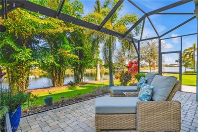 Peaceful views from the extended lanai / featuring outdoor lounge area, water views, and screened enclosure. | Image 2