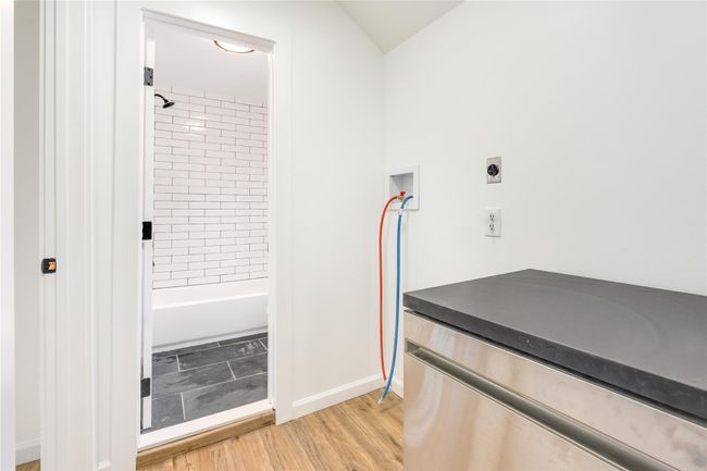 Bathroom featuring bathing tub / shower combination, baseboards, and wood finished floors | Image 11