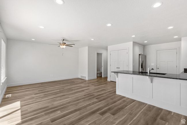 Kitchen featuring a sink, a kitchen breakfast bar, recessed lighting, baseboards, and ceiling fan | Image 15