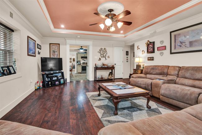 The large cozy living room shines with natural light coming through the Low E Windows. The warm colors draw you into the comfort of the room. | Image 8