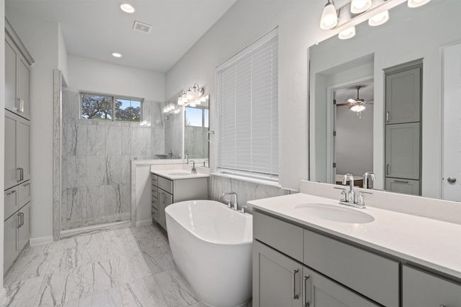 Bathroom with visible vents, marble finish floor, ceiling fan, a sink, and a walk in shower | Image 18