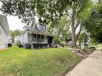 View of front facade featuring central AC unit, covered porch, and a front yard | Image 2