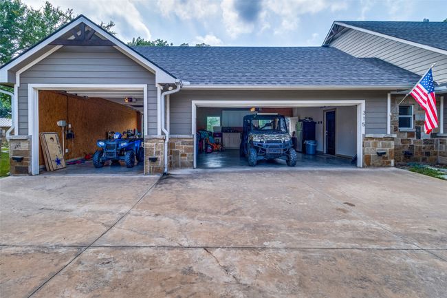 View of front of property with a garage and tandem garage that is perfect for boat storage | Image 36