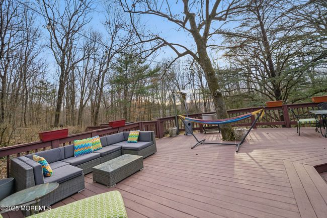 LARGE deck with privacy & nature with sliders to spacious living room & eat in Kitchen with separate Dining, Coffee bar, SS appliances and laundry room! | Image 49