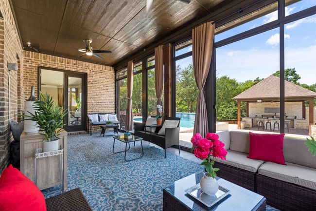 View of patio / terrace featuring outdoor lounge area, ceiling fan, an outdoor pool, a gazebo, and exterior kitchen | Image 33