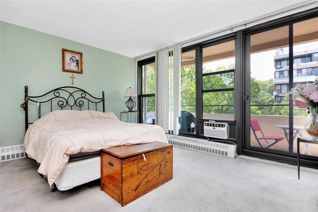 Bedroom with multiple windows, access to outside, carpet, a wall of windows, and a textured ceiling | Image 6