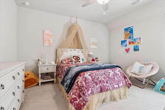 Bedroom featuring light carpet, visible vents, and a ceiling fan | Image 26