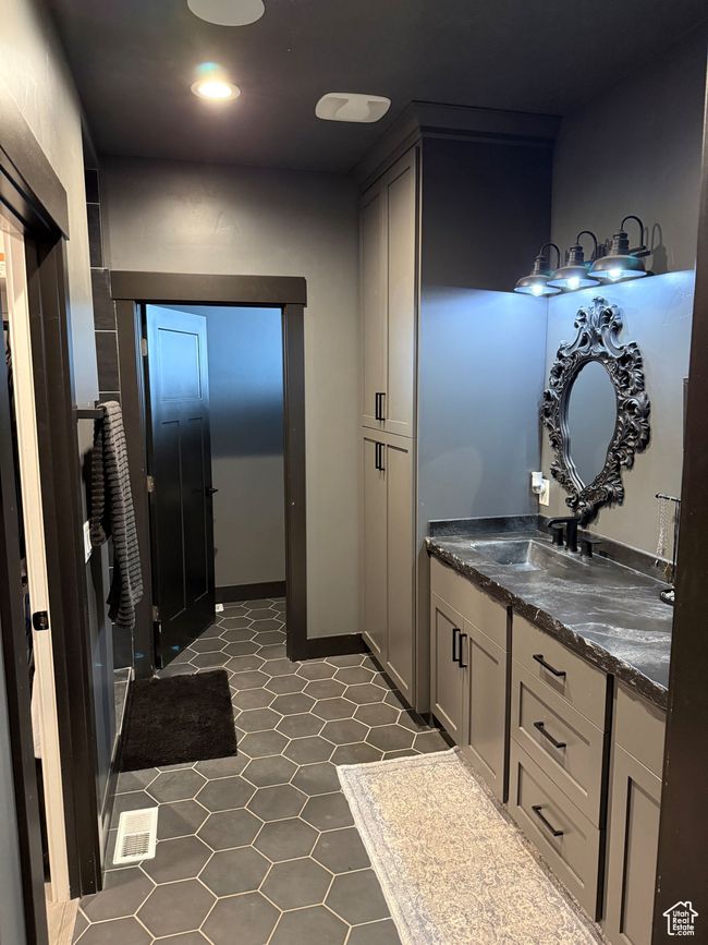 Bathroom featuring visible vents, tile patterned flooring, and vanity | Image 11