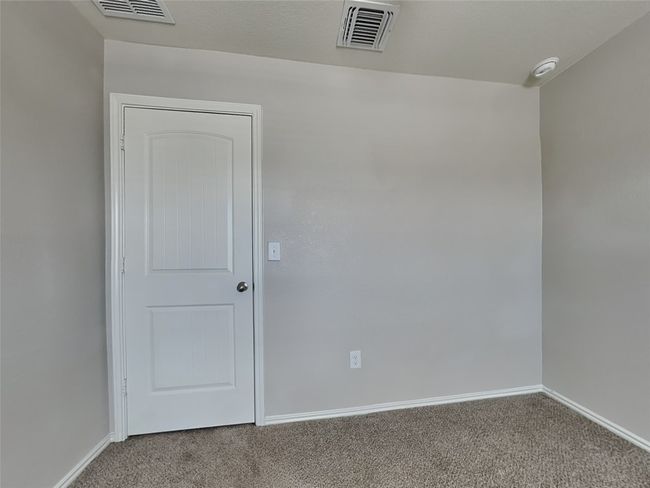 Carpeted empty room with baseboards and a smoke detector | Image 11