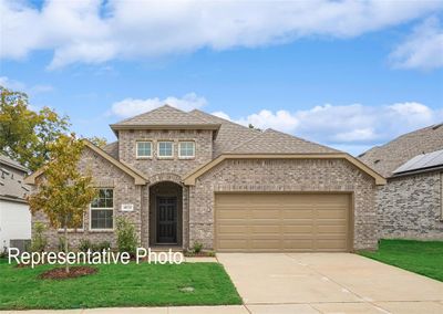 View of front of home with cooling unit, a garage, and a front yard | Image 1