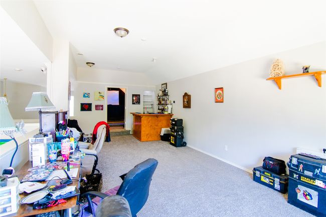 Carpeted office with lofted ceiling and baseboards | Image 22