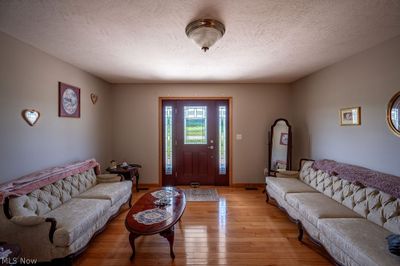 Living room featuring a textured ceiling and wood-type flooring | Image 3